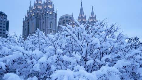 early morning view of the mormon temple in salt lake city, utah in the pre-dawn hour after a heavy snow storm - panning up to reveal the building