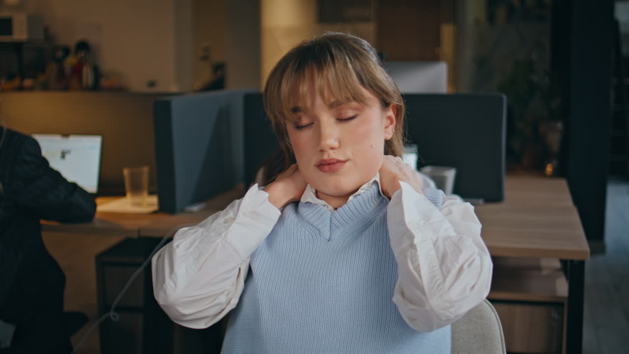 Exhausted manager rubbing neck at office evening closeup. Tired office worker