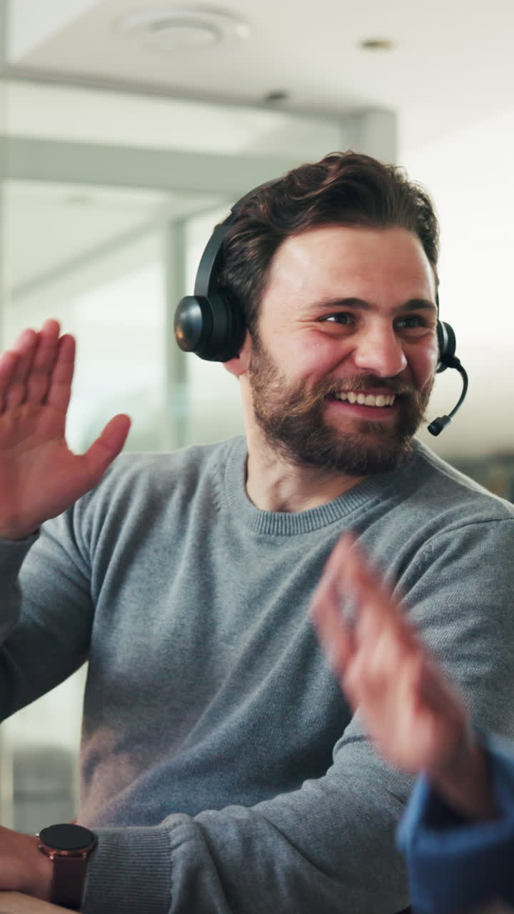 Bearded Man in Headset High-Fives Colleague in Office