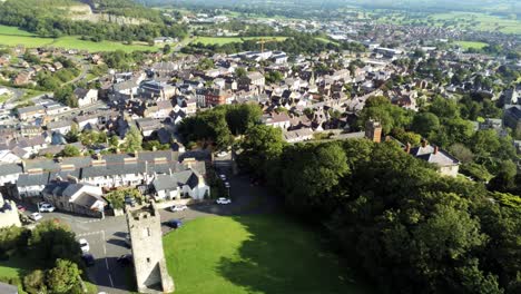 welsh medieval st hilarys tower denbighshire residential village north wales aerial left pan tilt down view