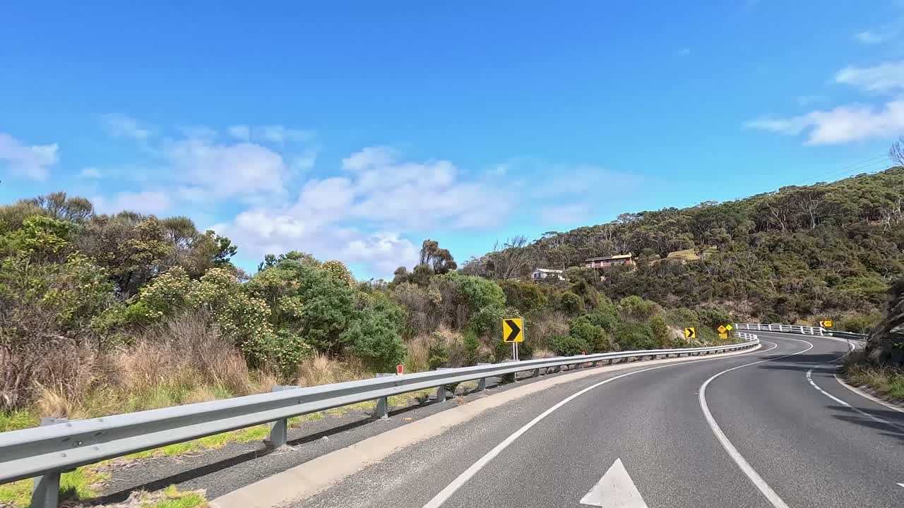 A 45-second video capturing a drive on Great Ocean Road, showcasing winding roads, lush greenery, and coastal views under clear skies