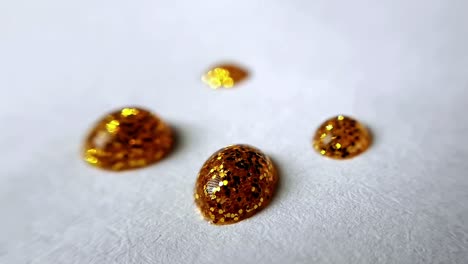 Four-golden-glittering-points-on-white-paper