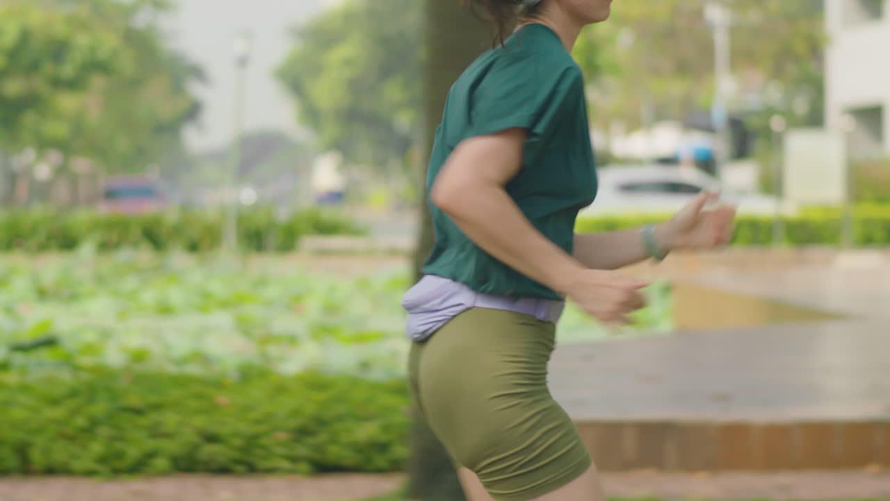 Athletic Woman Running Outdoors in City