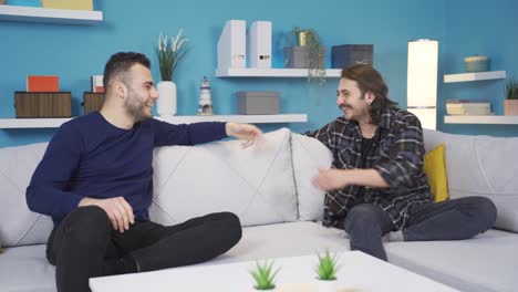 Happy-and-funny-boyfriends-chatting-at-home.