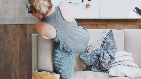 Overhead-Shot-Looking-Down-On-Woman-At-Home-Returning-From-Fitness-Class