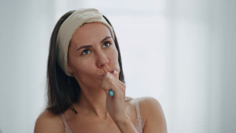 Closeup-carefree-girl-toothbrushing-at-bath-room.-Dancing-woman-brushing-teeth