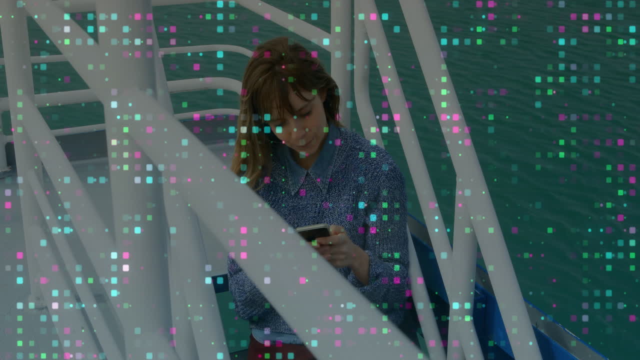 Woman using smartphone on boat with colorful digital data animation overlay