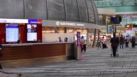 passengers walking through a busy airport terminal