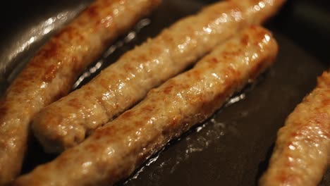 fried sausages in a pan