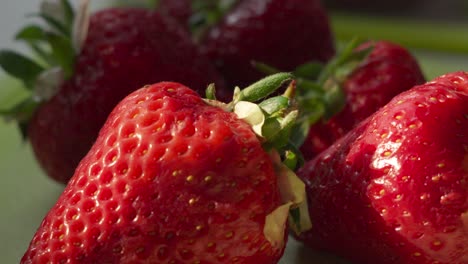 Close-Up-Slow-Motion-View-of-Fresh-Red-Strawberries-in-Bright-Sunlight