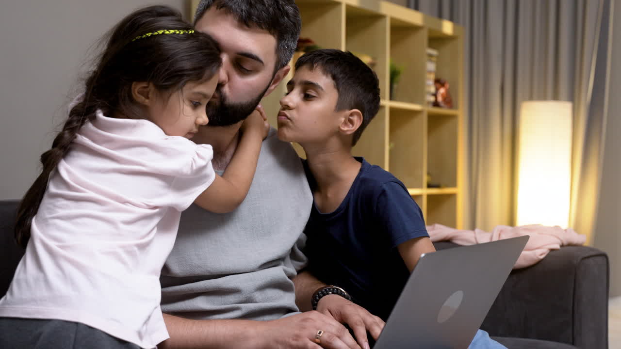 Father, daughter and son in the living room at home