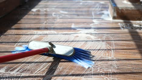 cleaning a tiled or wooden floor with soap and brush