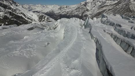 aerial view in the alps: snowy mountain and a glacier with cracks, winter, switzerland