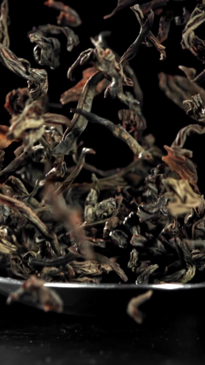 Loose Leaf Tea Falling onto a Spoon in Slow Motion