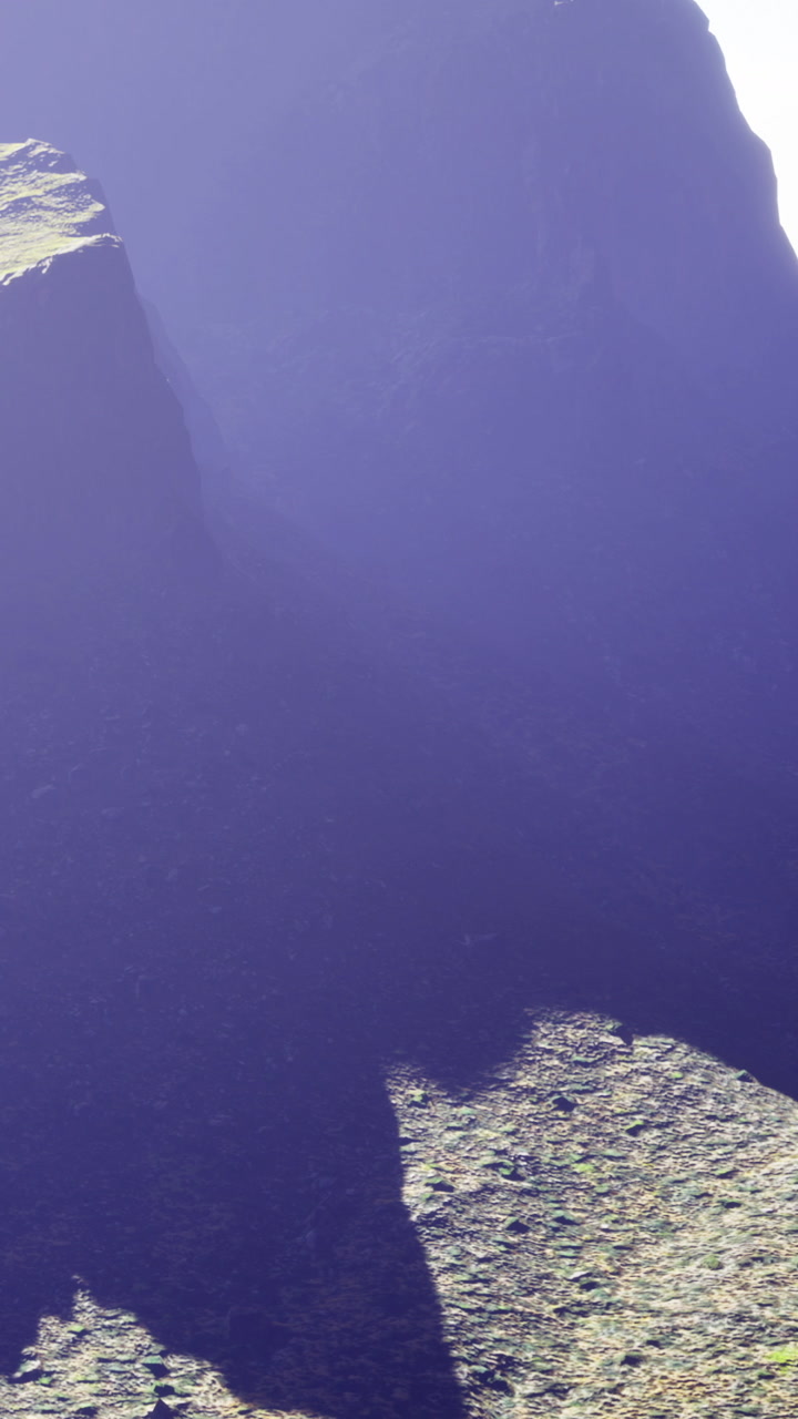 Majestic mountain peaks under soft morning light with deep shadows