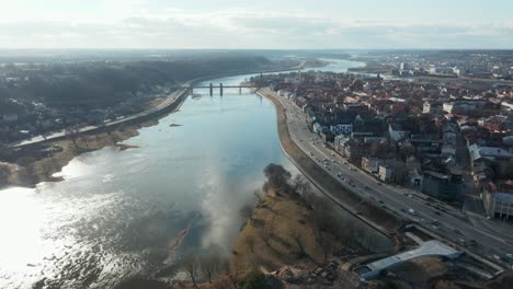 aerial: nemunas river with european capital of culture 2022 kaunas city panorama