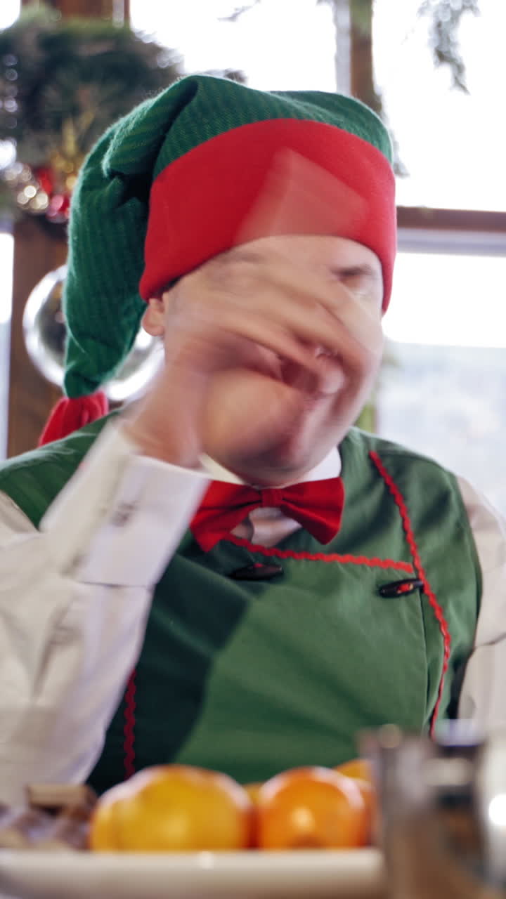 Male elf eating sweets. Vertical video