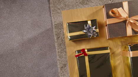 overhead shot of gifts or presents wrapped on table at home 2