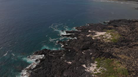 hawaii lava rocks and deep blue ocean coast