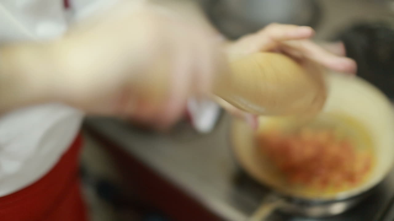 Chef In Restaurant Kitchen Cooking. Chef cook in uniform at the restaurant kitchen