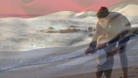 animation of flag of netherlands over caucasian mother and child walking on sunny beach