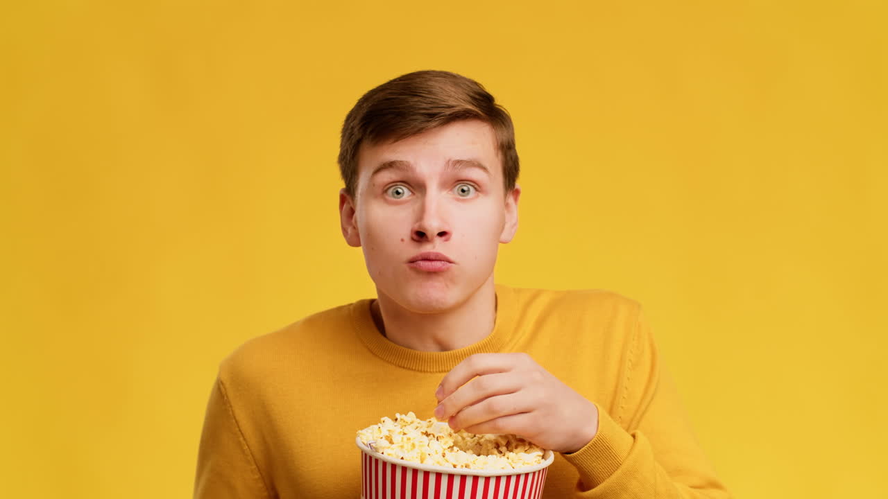 Man Surprised While Eating Popcorn