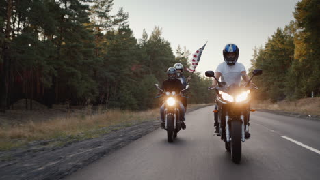 young people on high-speed motorcycles ride on the highway