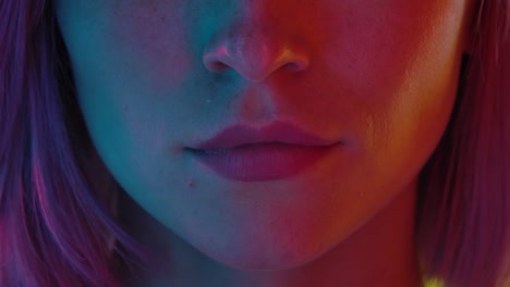 Woman's face and mouth with colorful neon light