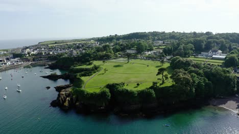 Aerial View of a Coastal Town with a Green Park and Harbor