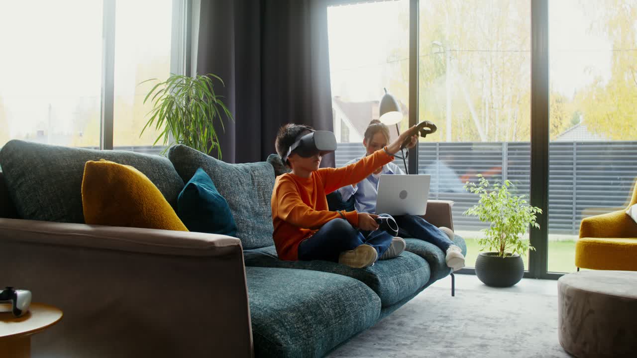 Kids enjoying VR and laptop on couch