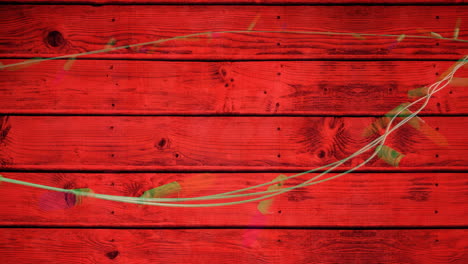 Animation-of-flickering-fairy-lights-with-copy-space-on-wooden-background