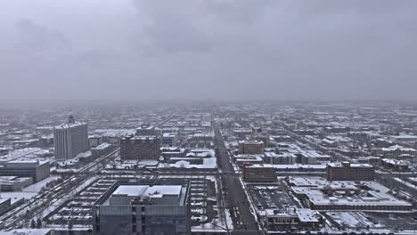 aerial trucking shot of snow-covered downtown salt lake city utah on gloomy day