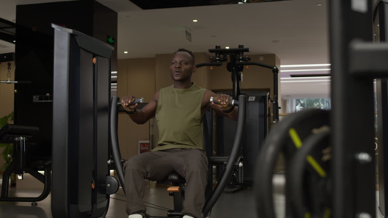Man working out on a chest press machine at the gym