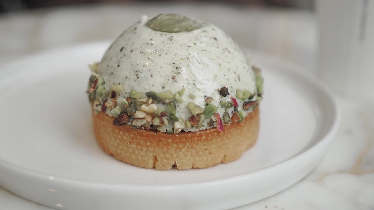 Close-up of a Pistachio Mousse Tart with Chopped Nuts