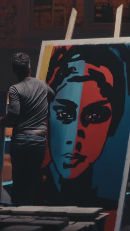 artist painting a colorful portrait in a studio