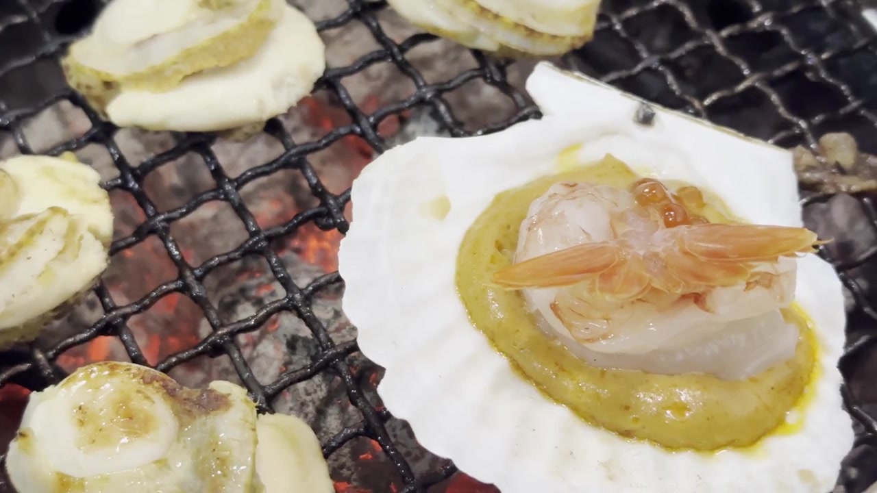 Close-up of fresh scallops grilling on a hot barbecue surface, capturing sizzling texture, rising steam, and delicious seafood cooking.