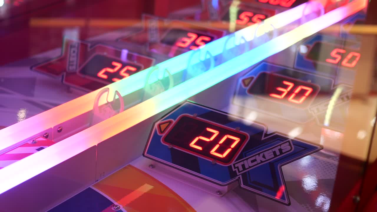 Close up of an arcade game machine with a digital display showing the number of tickets earned