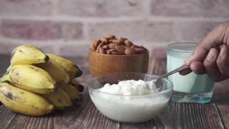 healthy breakfast with yogurt, almonds, and bananas