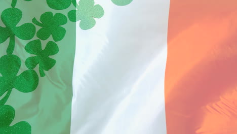 animation of flag of ireland over clovers