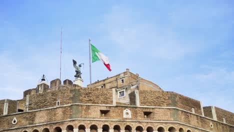 italian flag flying over the walls of castel sant'angelo in rome