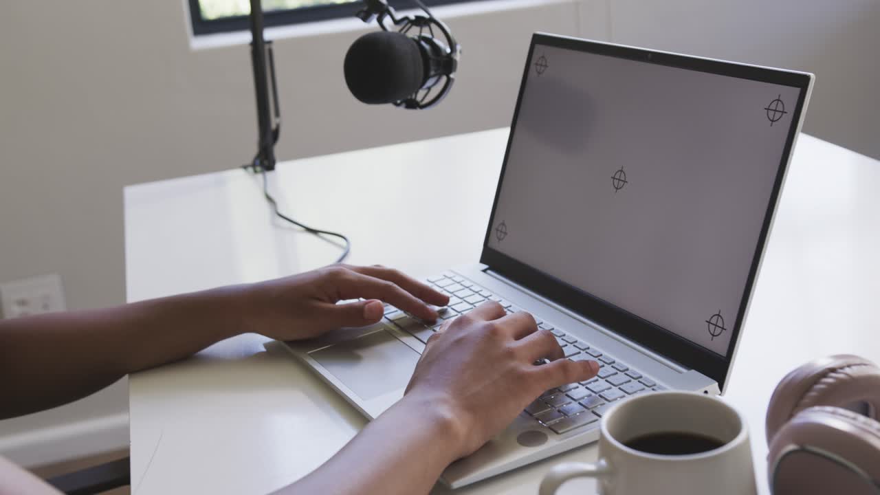 After resting on keyboard, hands are typing on laptop by window, briefly pausing for content work
