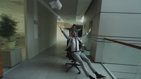 office fun: riding chairs and paper toss