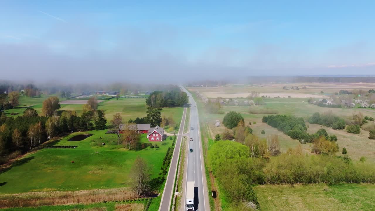 Drone captures A11 highway, Latvia with vehicles driving as fog drifts from sea