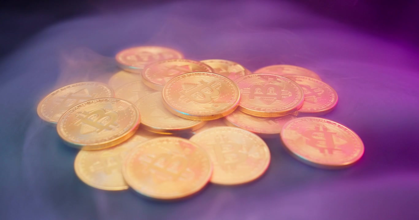 Golden Bitcoin Coins Surrounded by Purple Neon Smoke