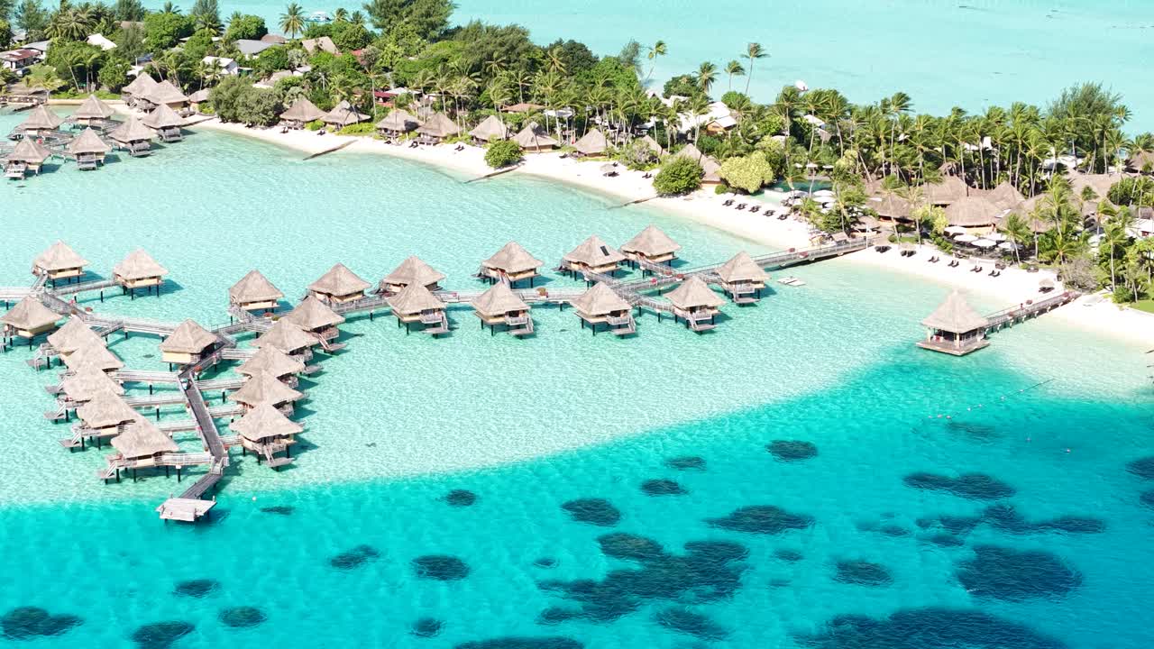 Bora Bora Island, French Polynesia. Aerial Shot of Luxury Tropical Resort, Overwater Bungalows and Turquoise Lagoon Water