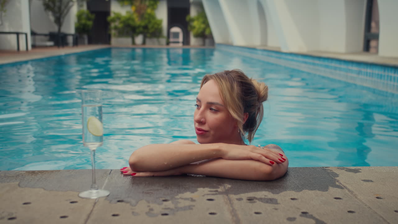 Portrait of Female Tourist Swimming in Pool and Drinking Cocktail at Resort