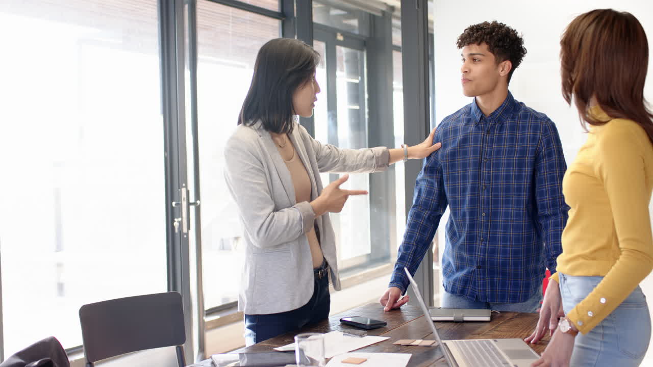 Interior design project, multiracial team with laptops and documents on table, at office