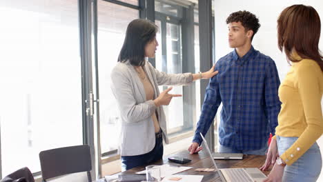 interior design project, multiracial team with laptops and documents on table, at office