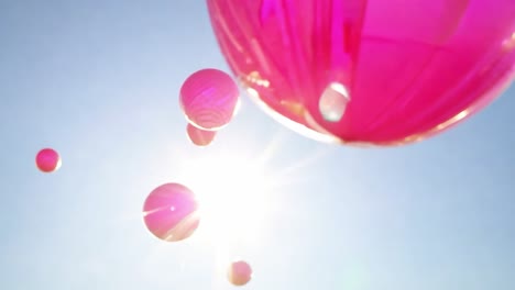 pink balloons float gracefully in a sunny sky, creating a cheerful atmosphere filled with joy and celebration