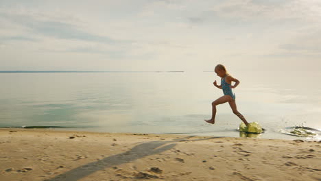 Funny-Girl-Runs-Along-The-Shore-Her-Feet-Touch-The-Water-And-Flies-A-Lot-Of-Splashing-Slow-Motion-Sh